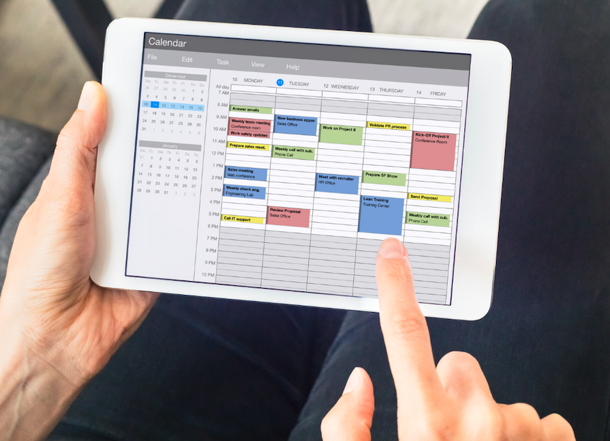 Fingers Hover Over Tablet Displaying A Weekly Schedule