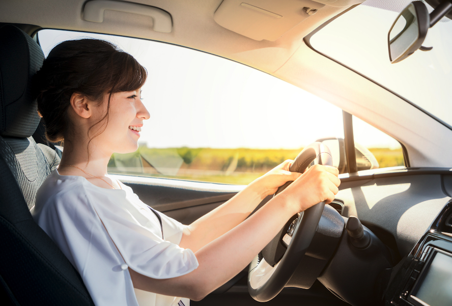Woman Looks At The Road Ahead While Driving Car